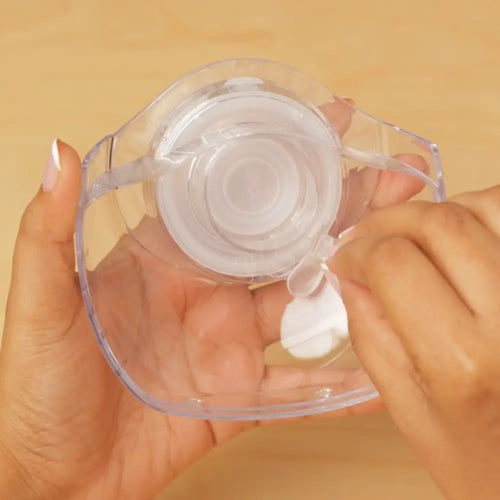 assembling the silicone valve in the ilk collection cup of the solyymoms breast pump