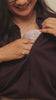 Mother using the Solyymoms wearable breast pump with hospital-grade suction while expressing milk into a baby bottle